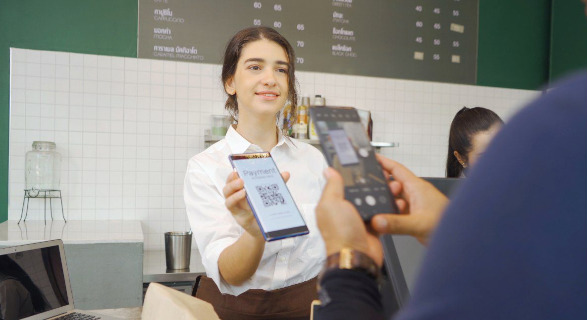 Woman Barista Taking Payment